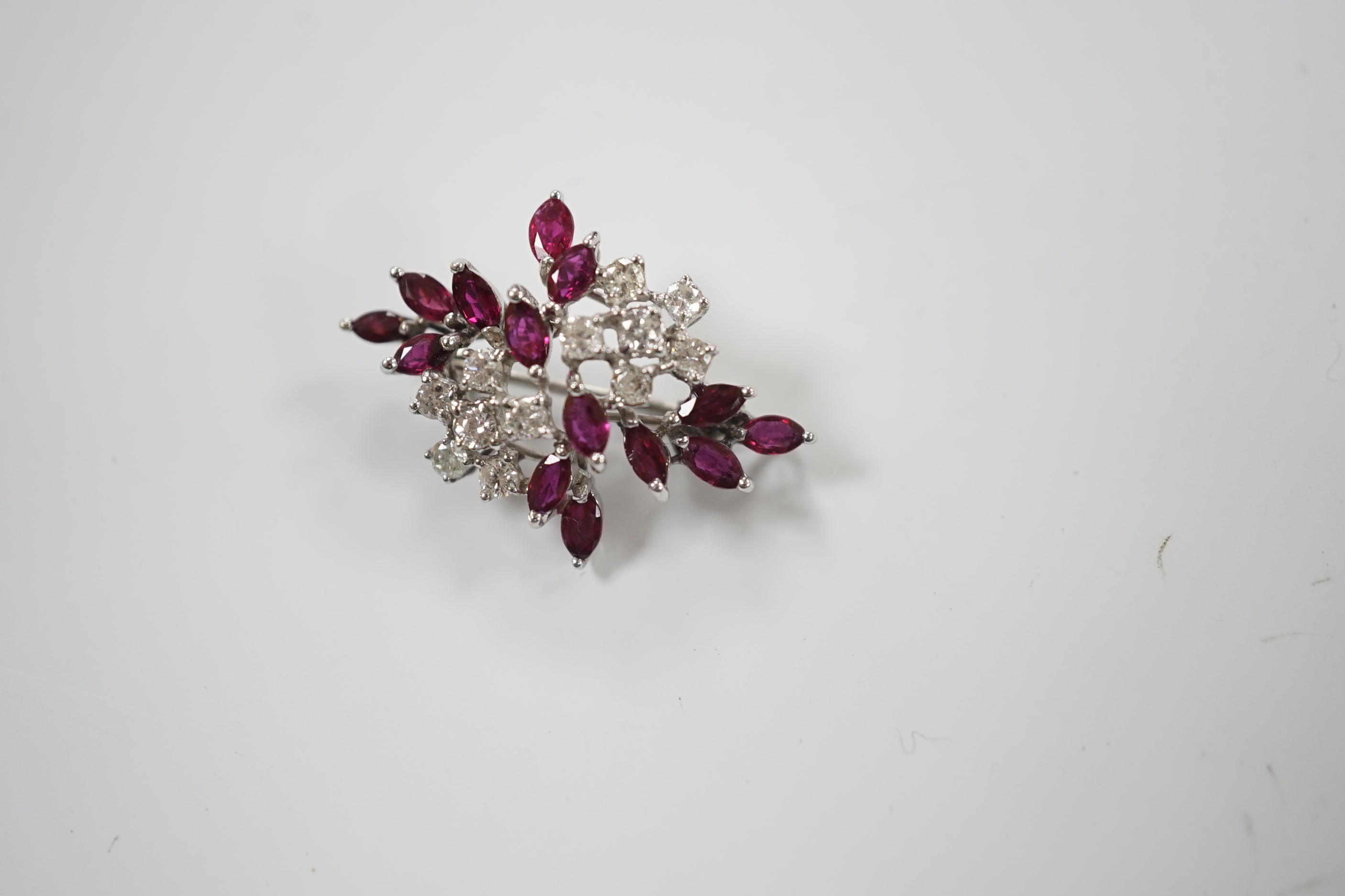 A modern white metal, ruby and diamond cluster set foliate spray pendant brooch, 32mm, gross weight 5.4 grams.